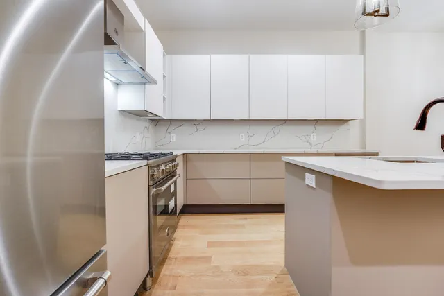 a kitchen with a sink a stove and cabinets