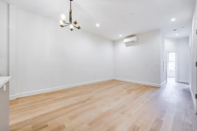 a view of a room with wooden floor and window