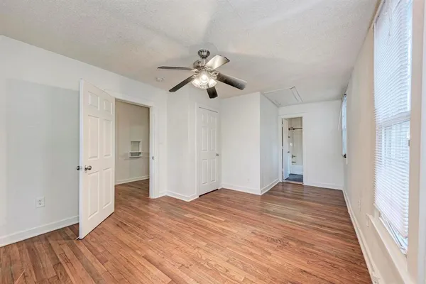 a bedroom with a bed and a ceiling fan