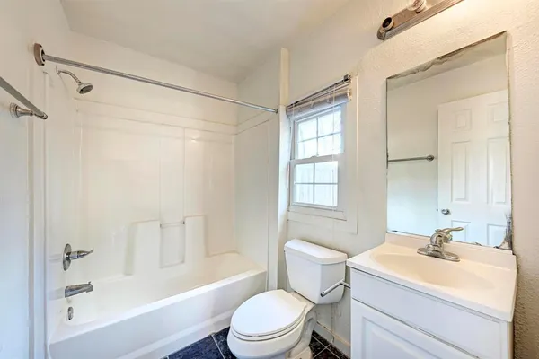 a bathroom with a sink toilet a mirror and shower