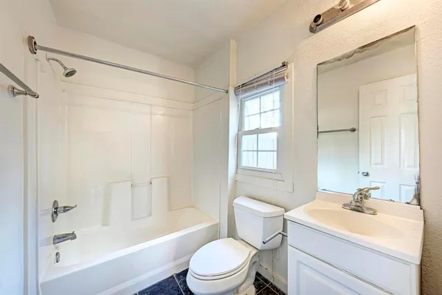 a bathroom with a sink toilet a mirror and shower