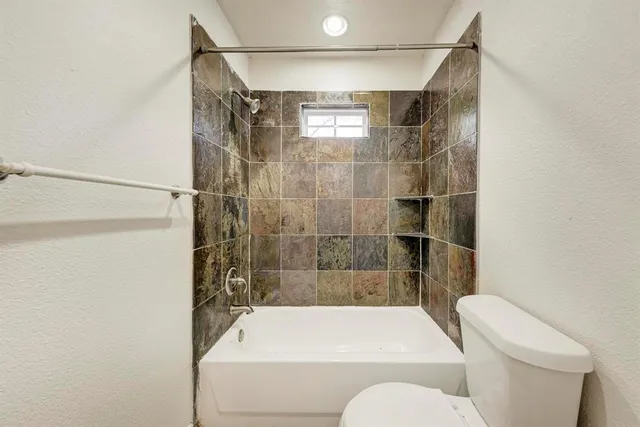a bathroom with a shower and toilet