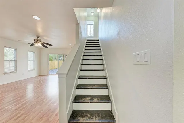 a view of entryway and hall with wooden floor