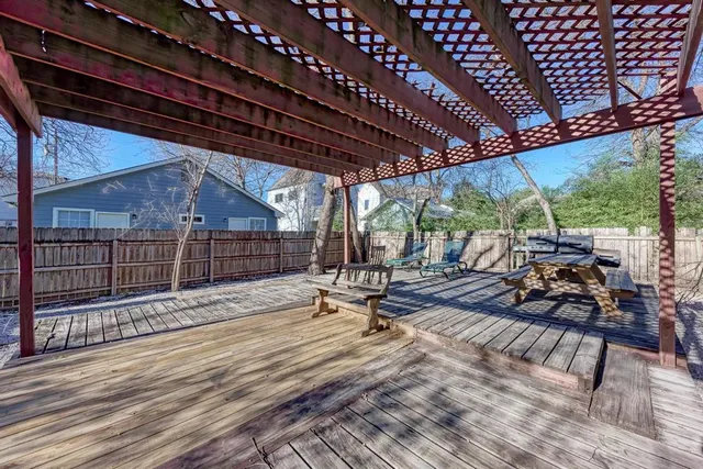 a view of a patio with table and chairs next to a yard