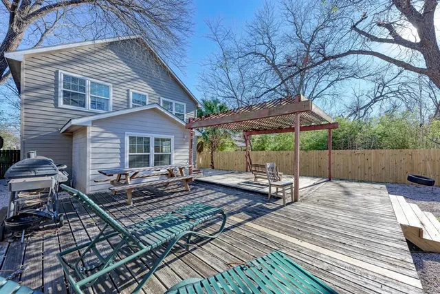 a view of house with backyard and wooden floor