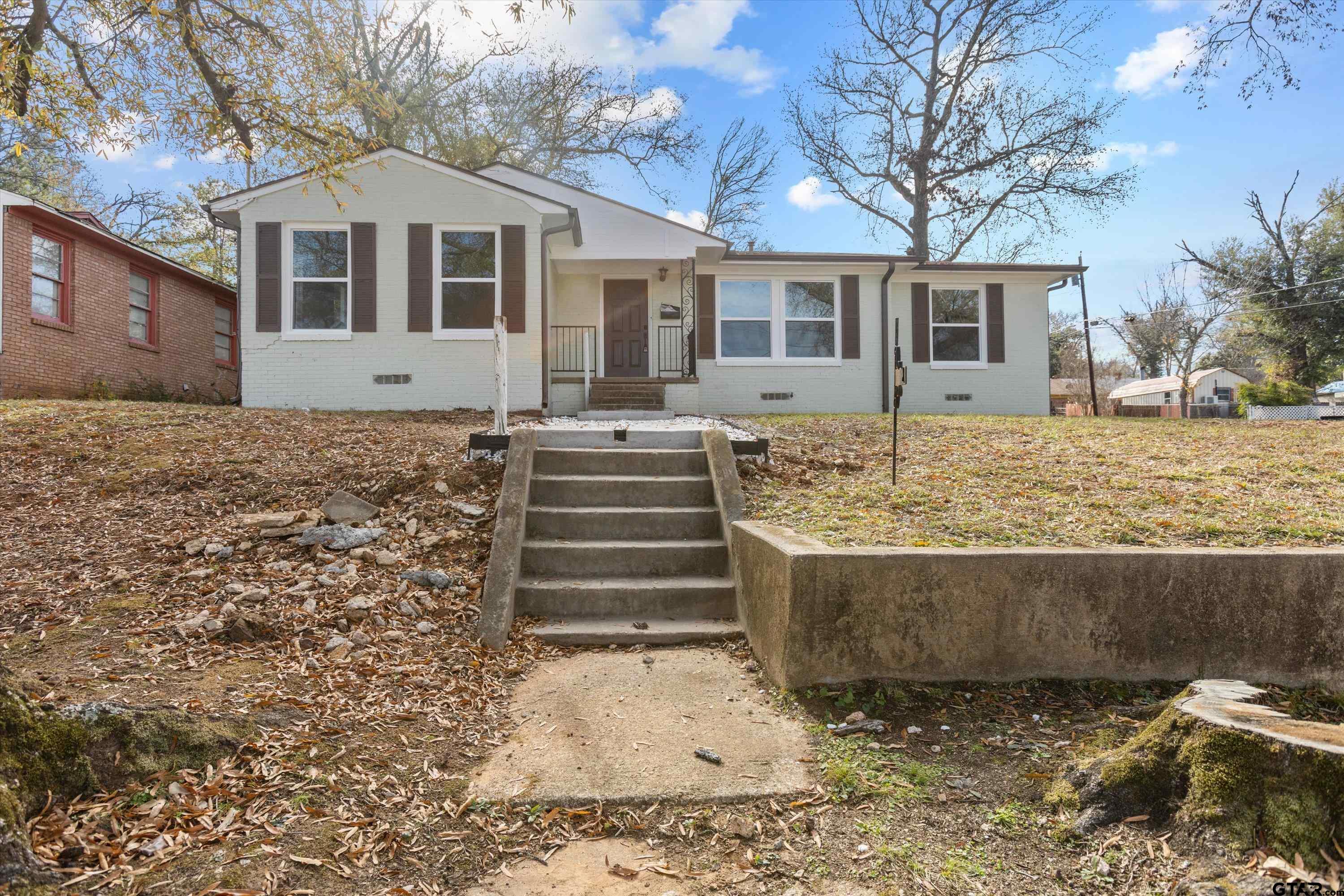 1330 Graham Drive Tyler, TX 75701 - Photo 1 of 22 a front view of a house with a yard
