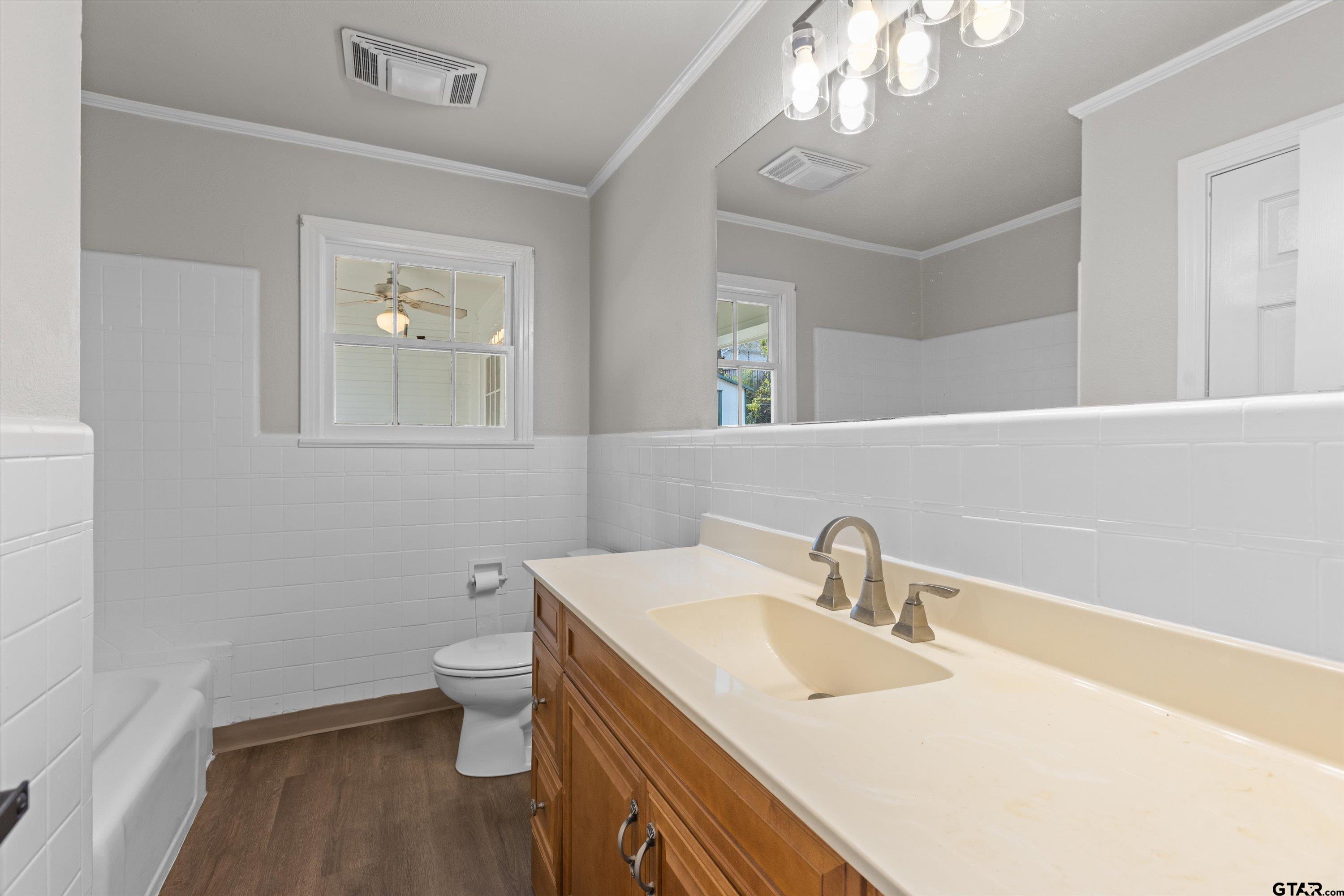 1330 Graham Drive Tyler, TX 75701 - Photo 18 of 22 a bathroom with a sink a toilet and a mirror