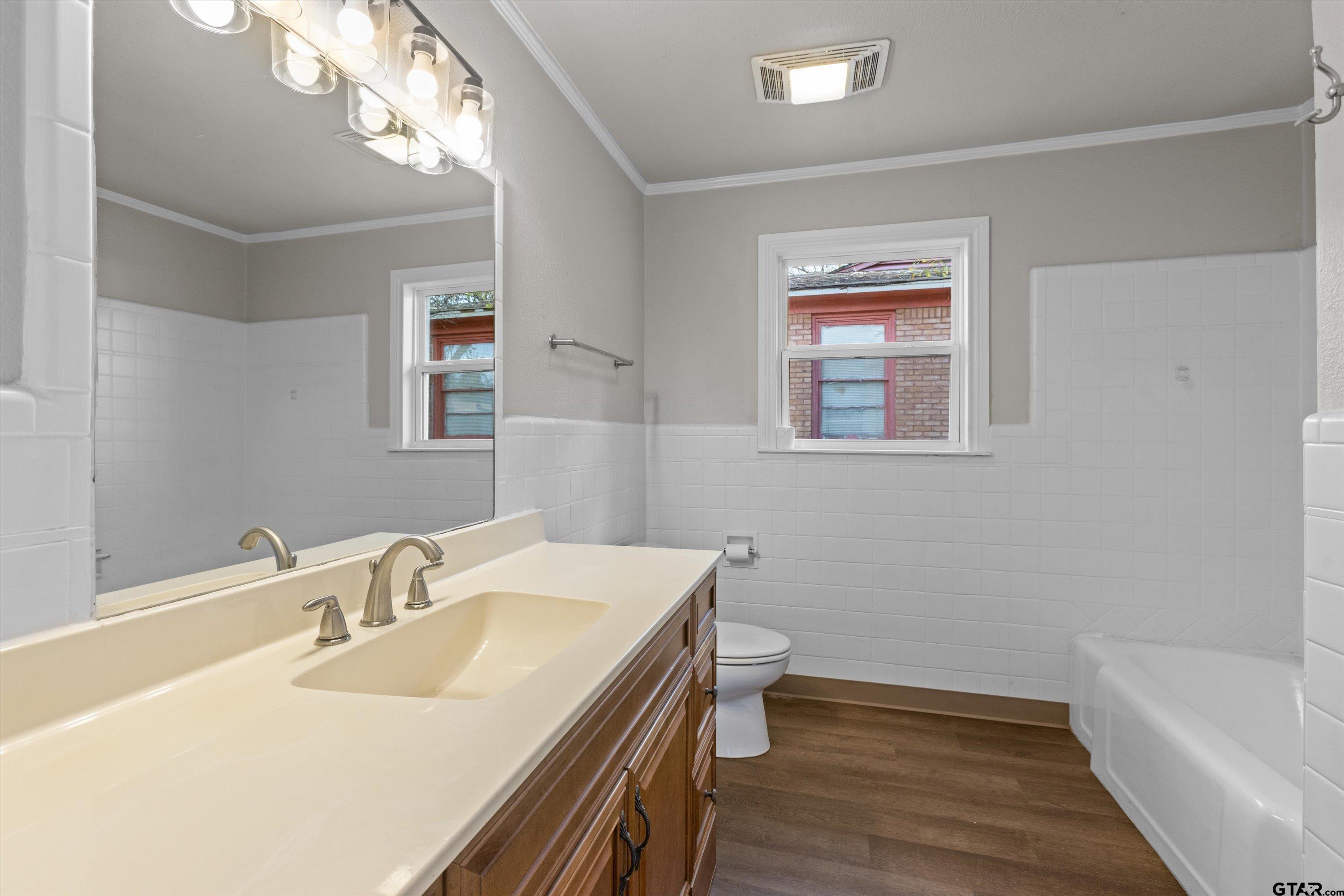 1330 Graham Drive Tyler, TX 75701 - Photo 19 of 22 a bathroom with a sink a toilet and a bathtub