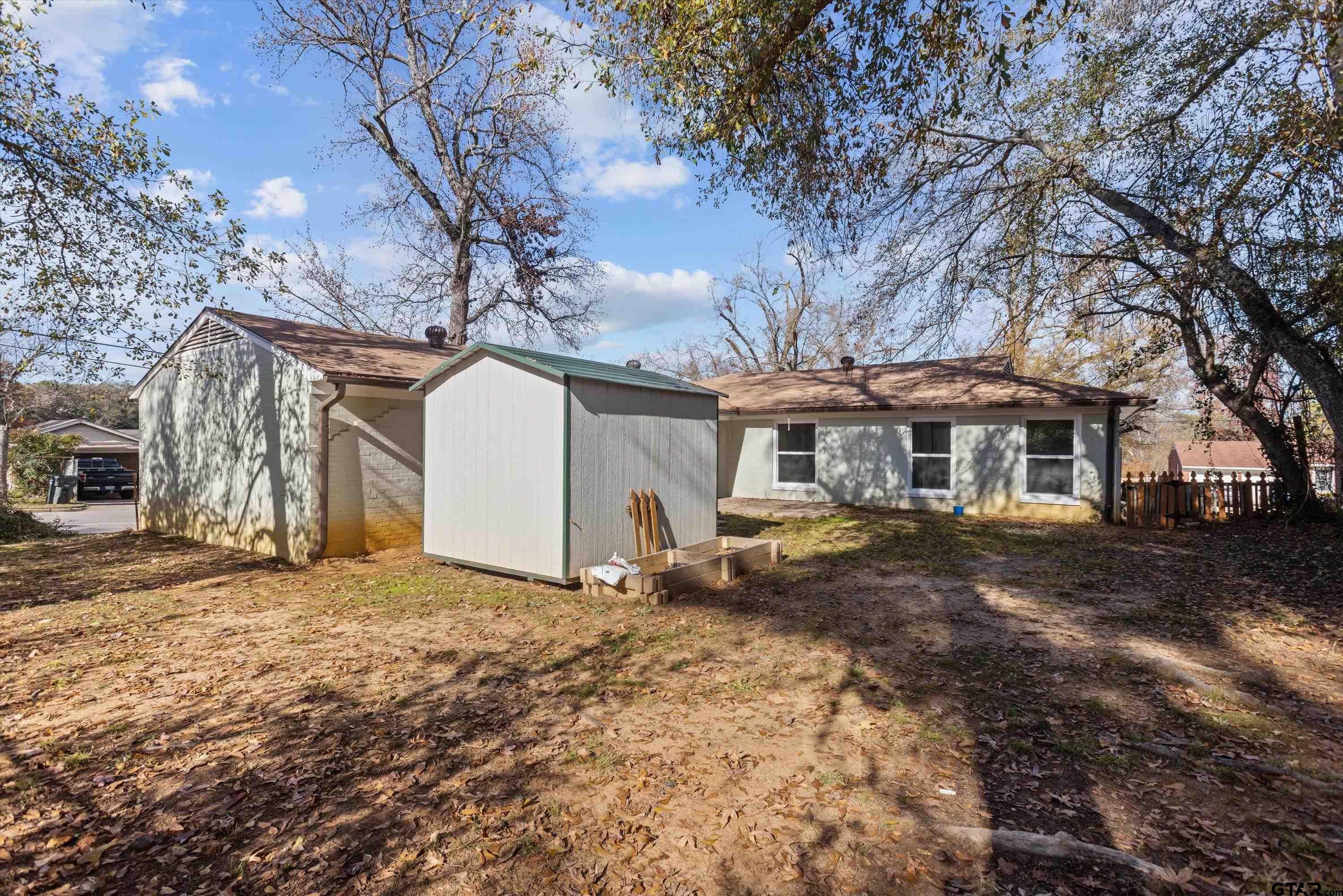 1330 Graham Drive Tyler, TX 75701 - Photo 21 of 22 a view of a yard in front of a house with a large tree
