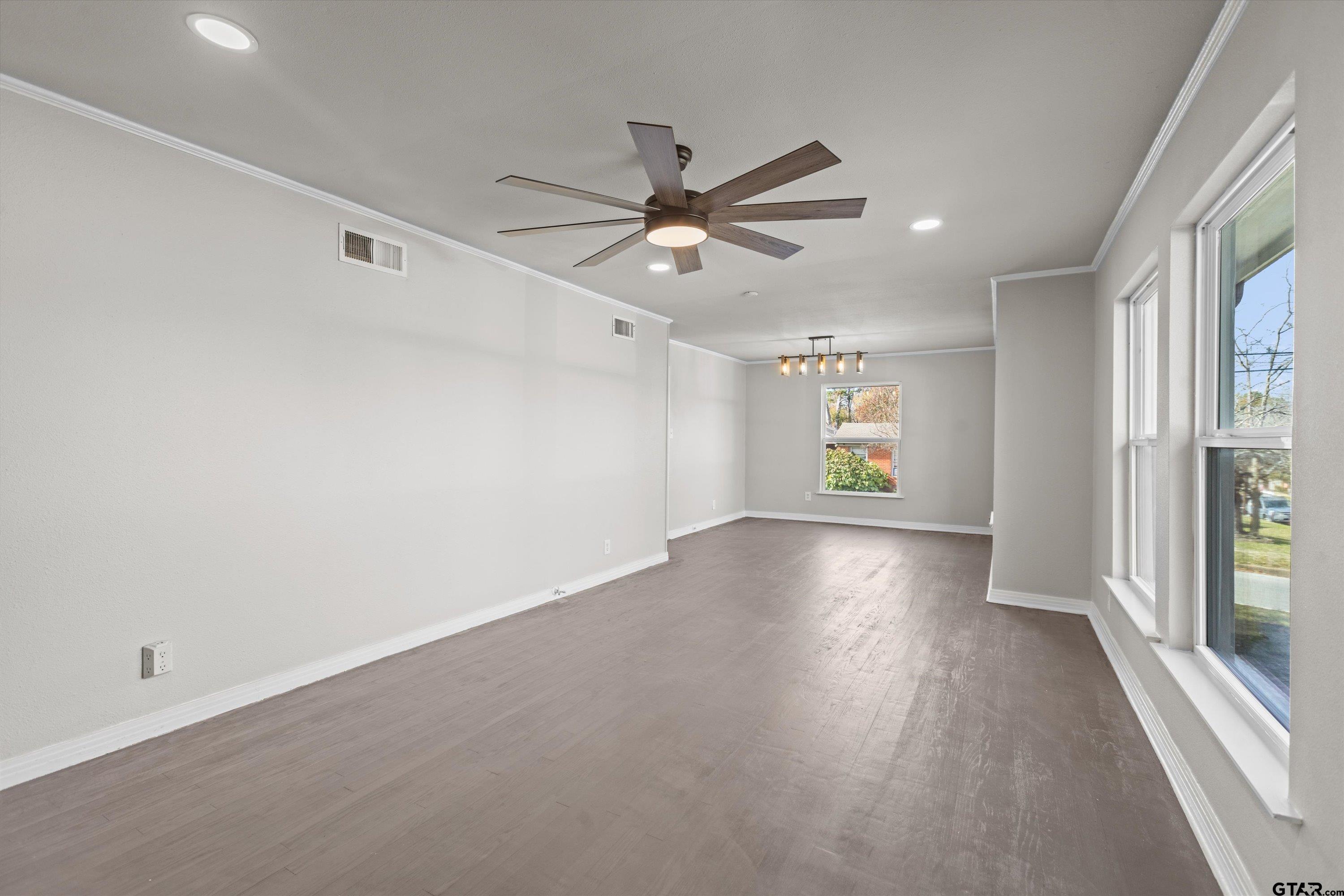 1330 Graham Drive Tyler, TX 75701 - Photo 3 of 22 wooden floor in an empty room with a window