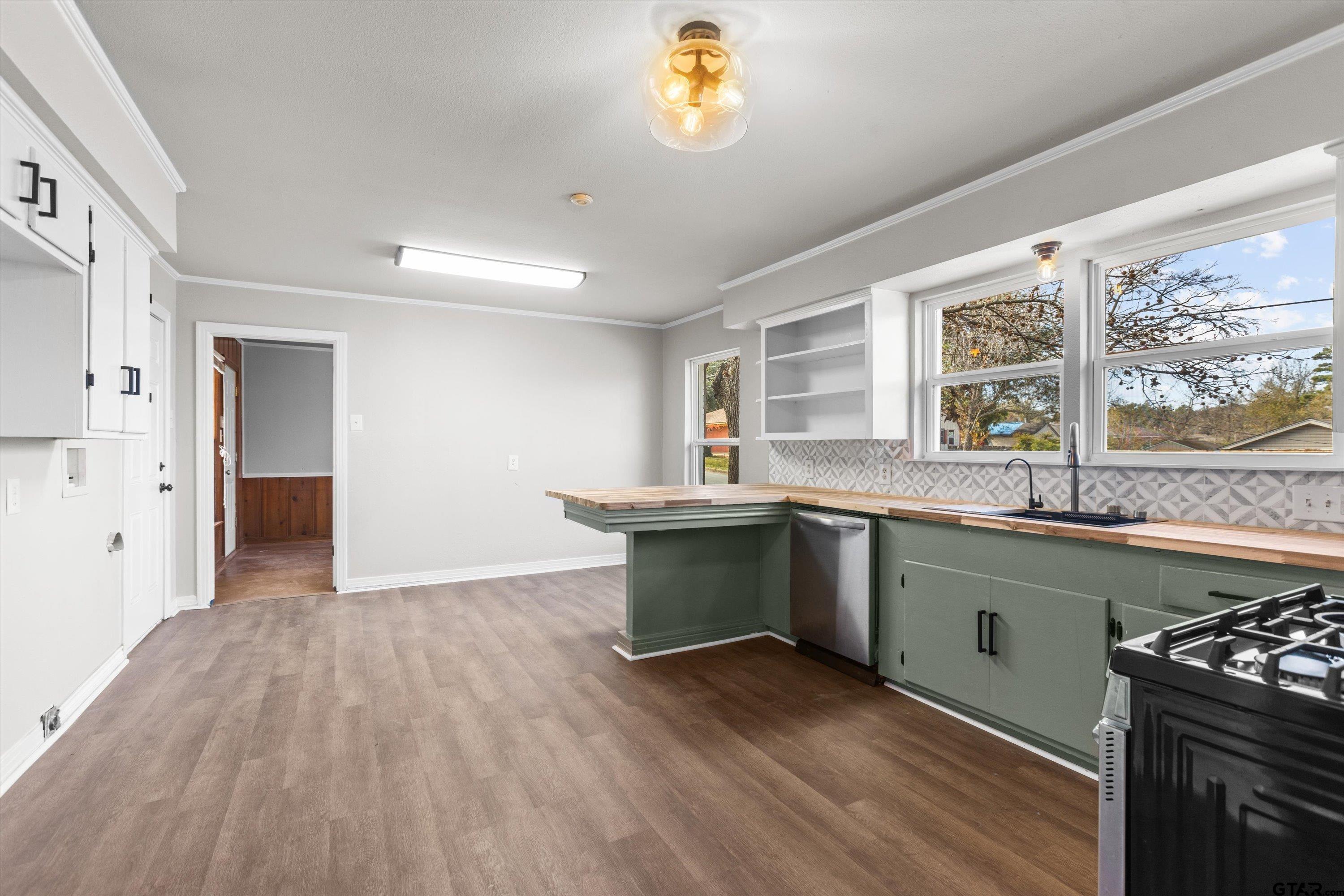 1330 Graham Drive Tyler, TX 75701 - Photo 8 of 22 a kitchen with granite countertop a stove and a sink