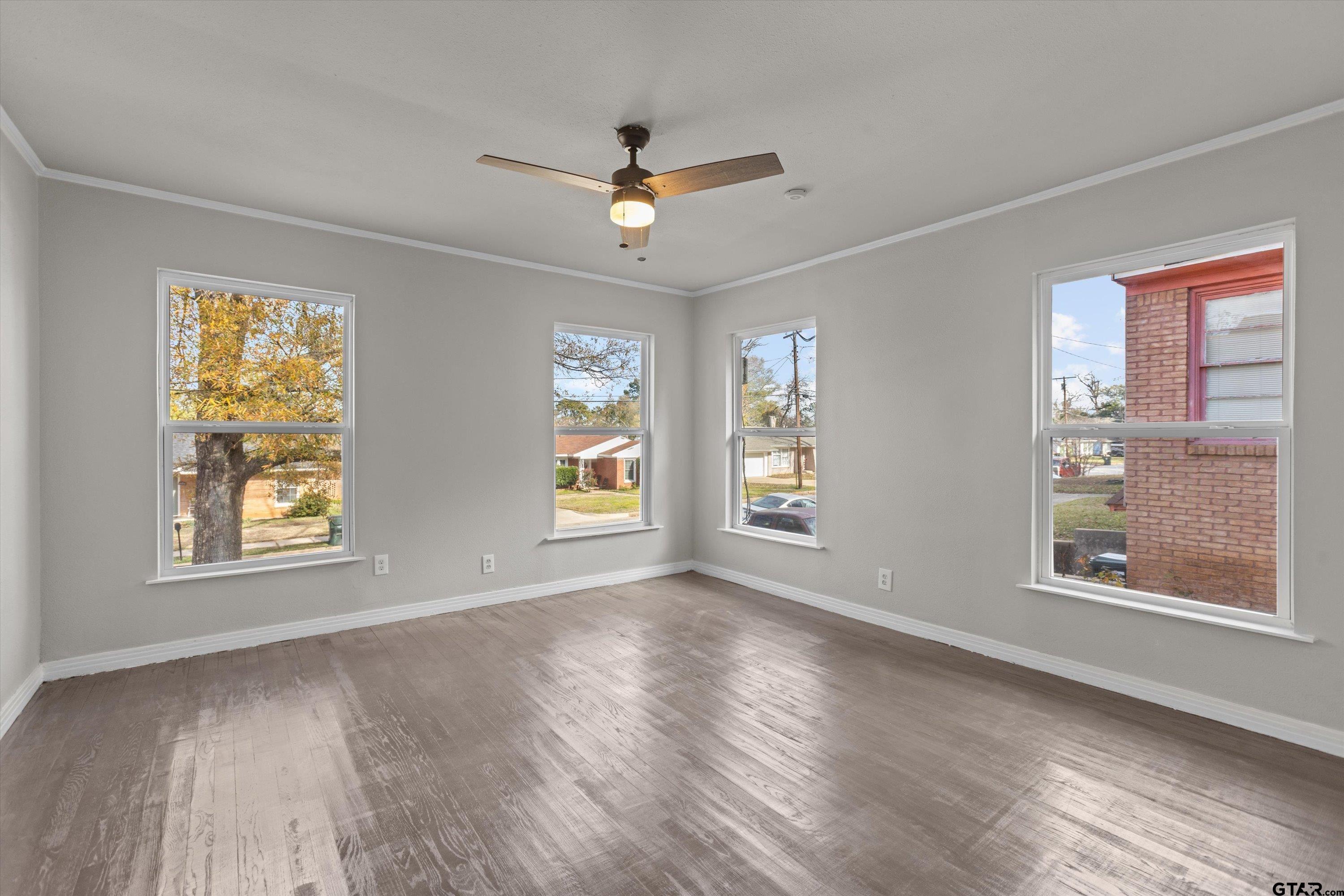 1330 Graham Drive Tyler, TX 75701 - Photo 10 of 22 a view of an empty room with a window and wooden floor