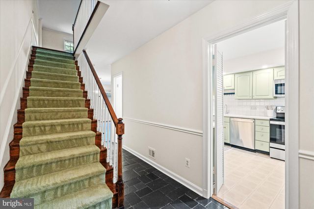 a view of an entryway with wooden floor and staircase