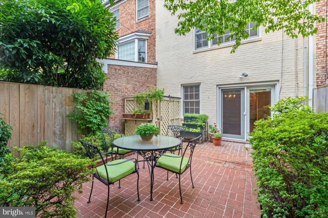 a view of a chairs and table in patio of the house