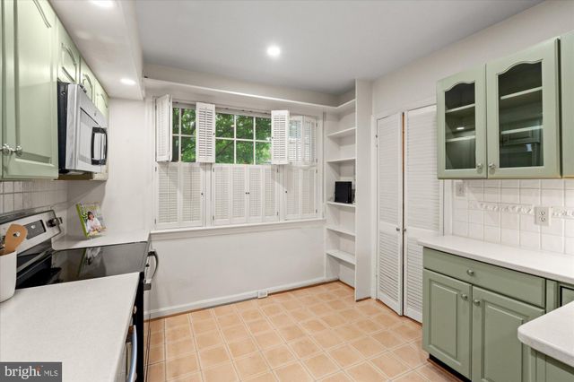 a spacious bathroom with a granite countertop sink a mirror and a bathtub