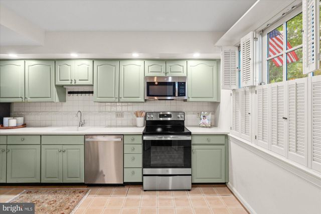 a kitchen with a sink stove and microwave