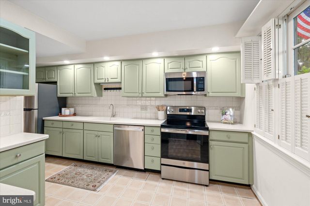 a kitchen with a sink and a stove top oven