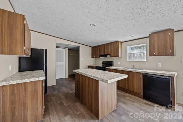 a kitchen with a stove sink and cabinets