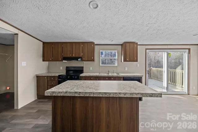 a kitchen with a stove a sink and a refrigerator