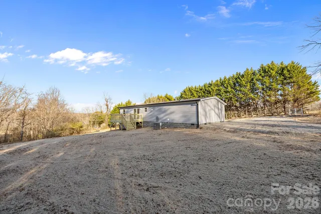 a backyard of a house with large trees