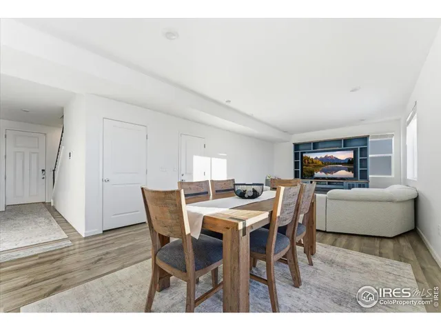a dining room with furniture and wooden floor