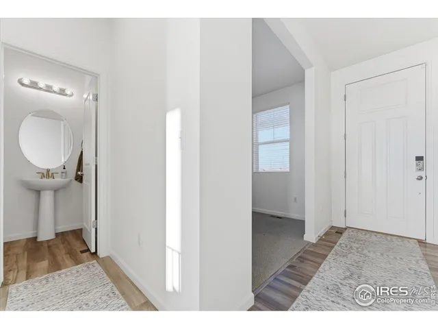 a view of a hallway and wooden floor