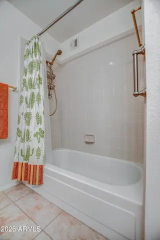 a bathroom with a bathtub and shower