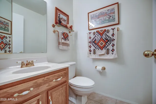 a bathroom with a toilet a sink and a mirror
