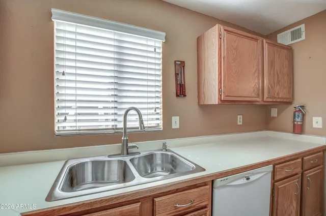 a kitchen with a sink cabinets and window