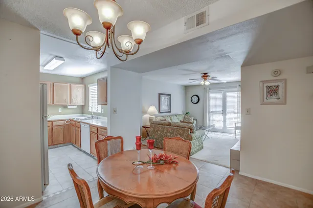 a view of a dining room with furniture and a chandelier