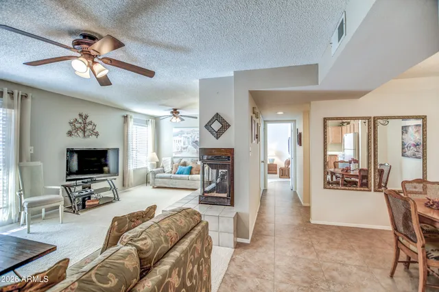 a living room with furniture a fireplace and a flat screen tv