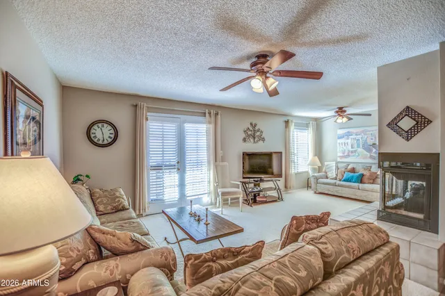 a living room with furniture a fireplace and a flat screen tv
