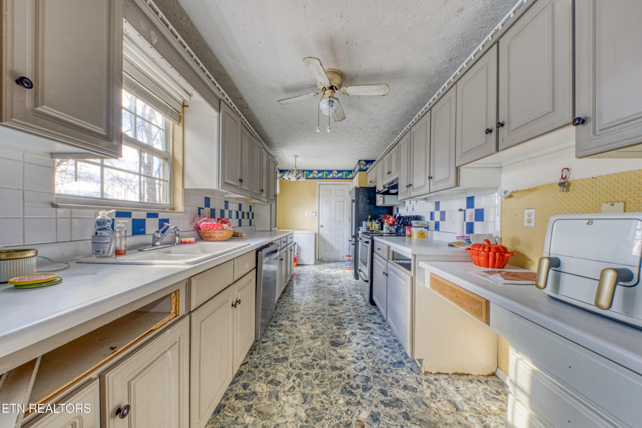 7700 McDaniel Road Knoxville, TN 37924 - Photo 13 of 18 a kitchen that has a lot of cabinets in it and wooden floors
