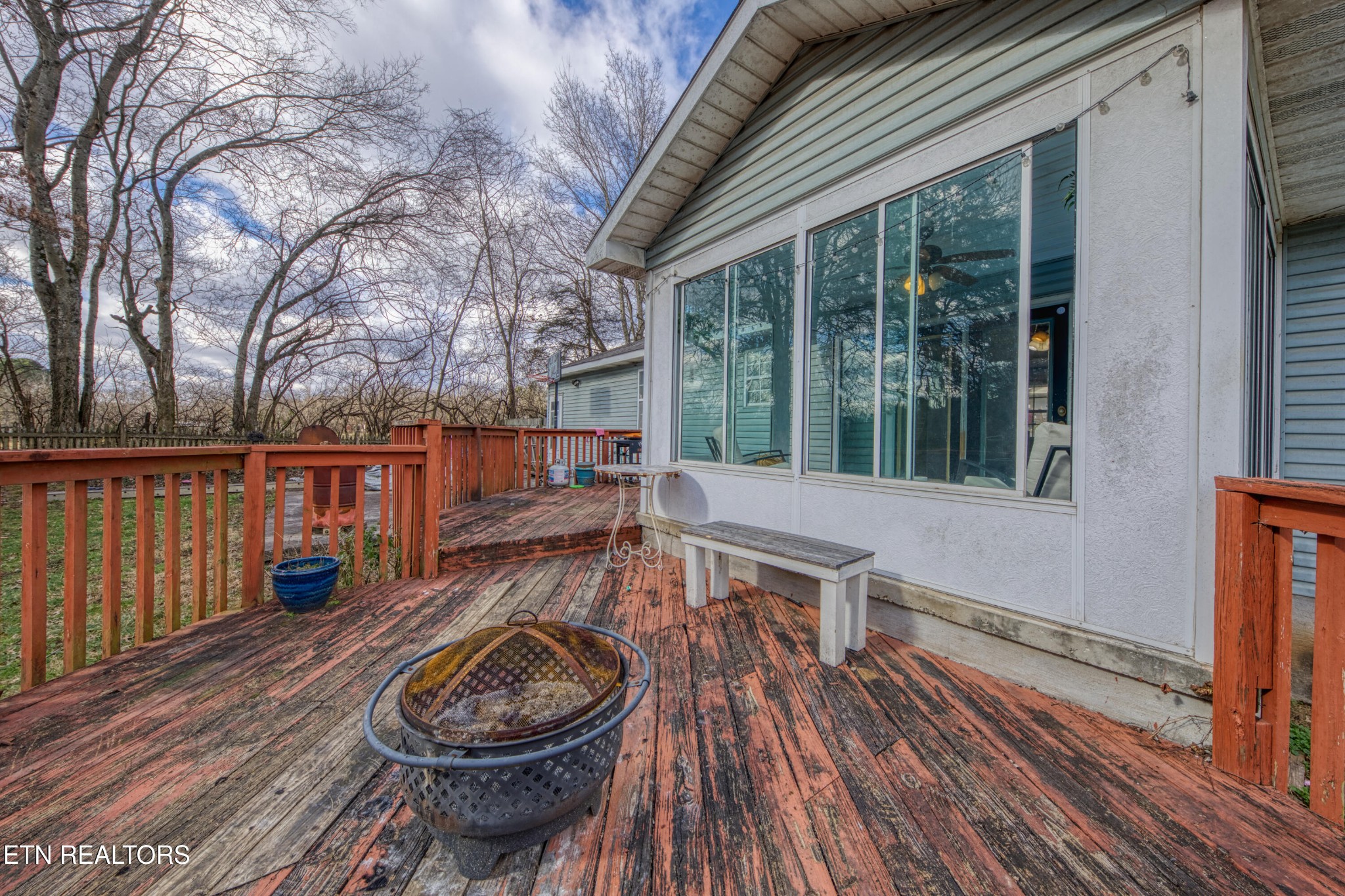 7700 McDaniel Road Knoxville, TN 37924 - Photo 7 of 18 a backyard of a house with wooden floor barbeque oven and outdoor seating
