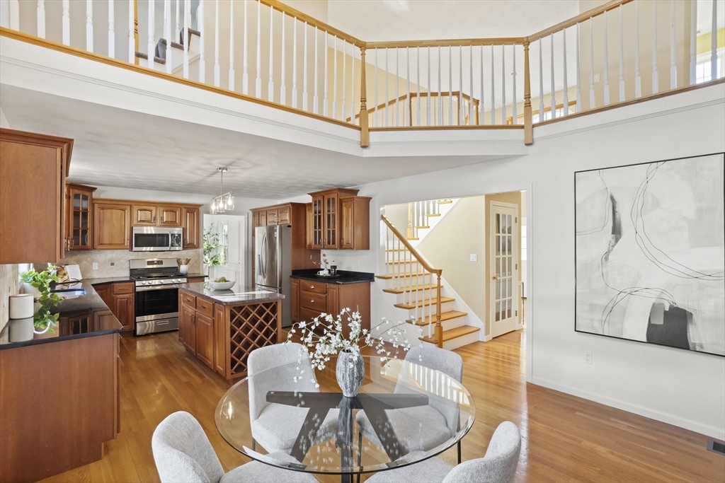 7 Eagles Nest Road Westford, MA 01886 - Photo 2 of 42 a living room with furniture a wooden floor and a chandelier