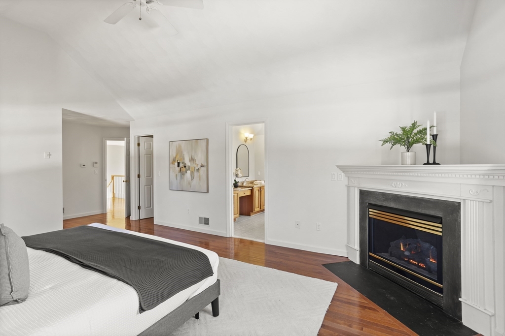 7 Eagles Nest Road Westford, MA 01886 - Photo 24 of 42 a bedroom with a bed and a fireplace