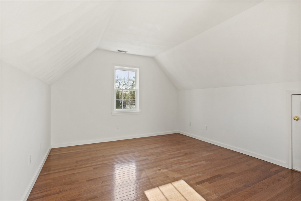 7 Eagles Nest Road Westford, MA 01886 - Photo 29 of 42 an empty room with wooden floor and windows