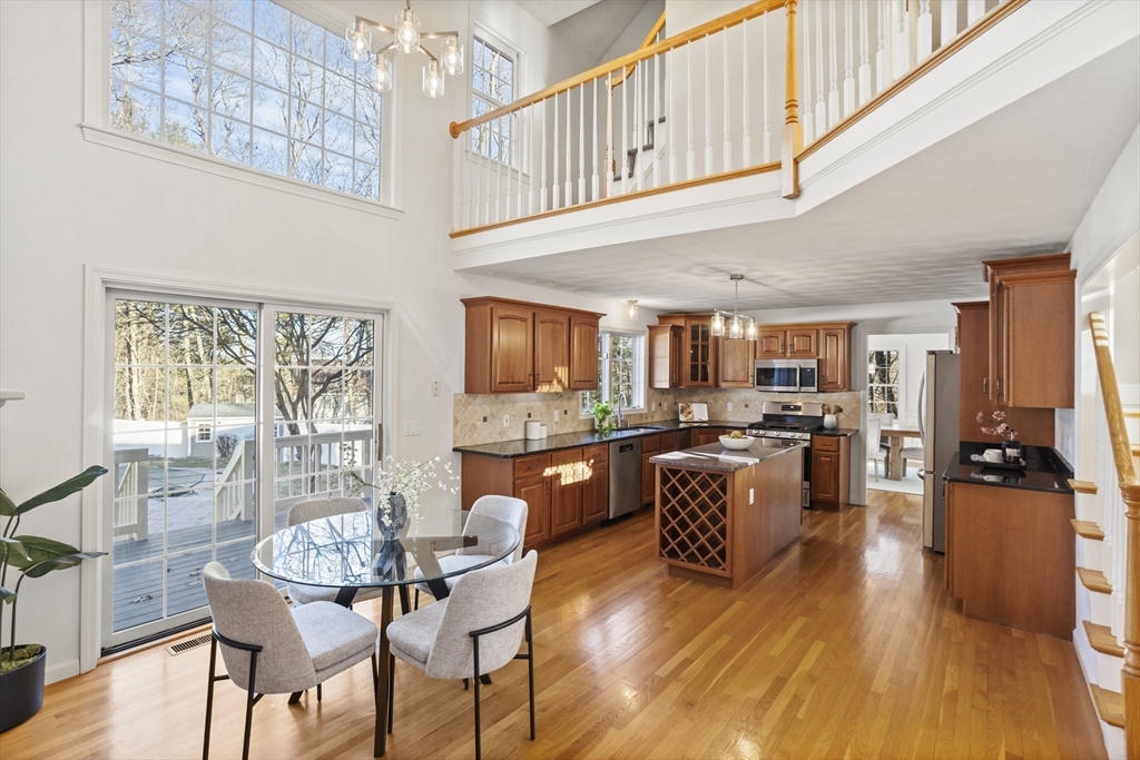 7 Eagles Nest Road Westford, MA 01886 - Photo 9 of 42 a kitchen with a table chairs and flat screen tv