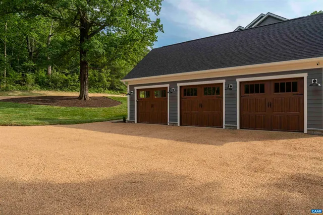 front view of a house with a yard and trees