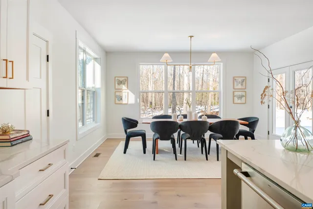 a view of a dining room with furniture and chandelier