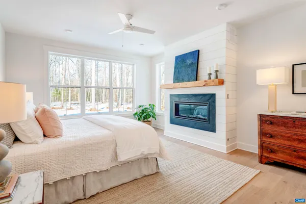a bedroom with a bed and a fireplace