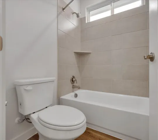 a bathroom with a toilet and a bathtub