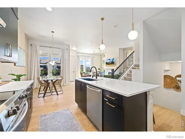 a very nice looking dining room with a large center island and furniture