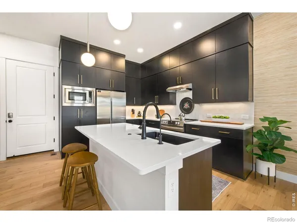a kitchen with a sink cabinets and wooden floor