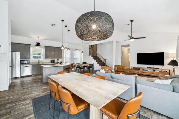 an open kitchen with dining table and chairs