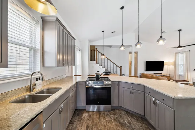 a kitchen with a sink stove and microwave