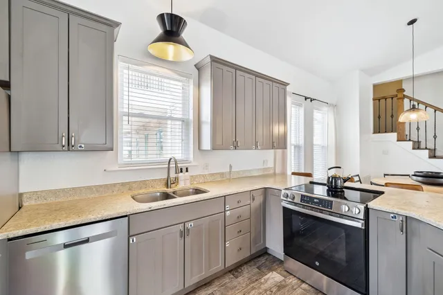 a kitchen with a sink stove and cabinets
