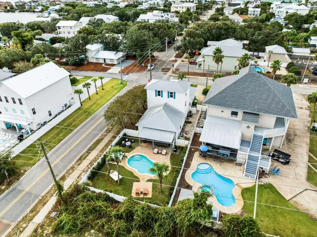 an aerial view of a house with a swimming pool and outdoor seating