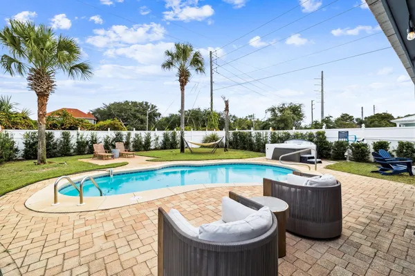 a view of swimming pool with seating area and barbeque oven