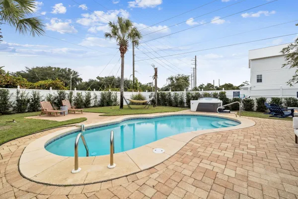 a swimming pool with outdoor seating and yard